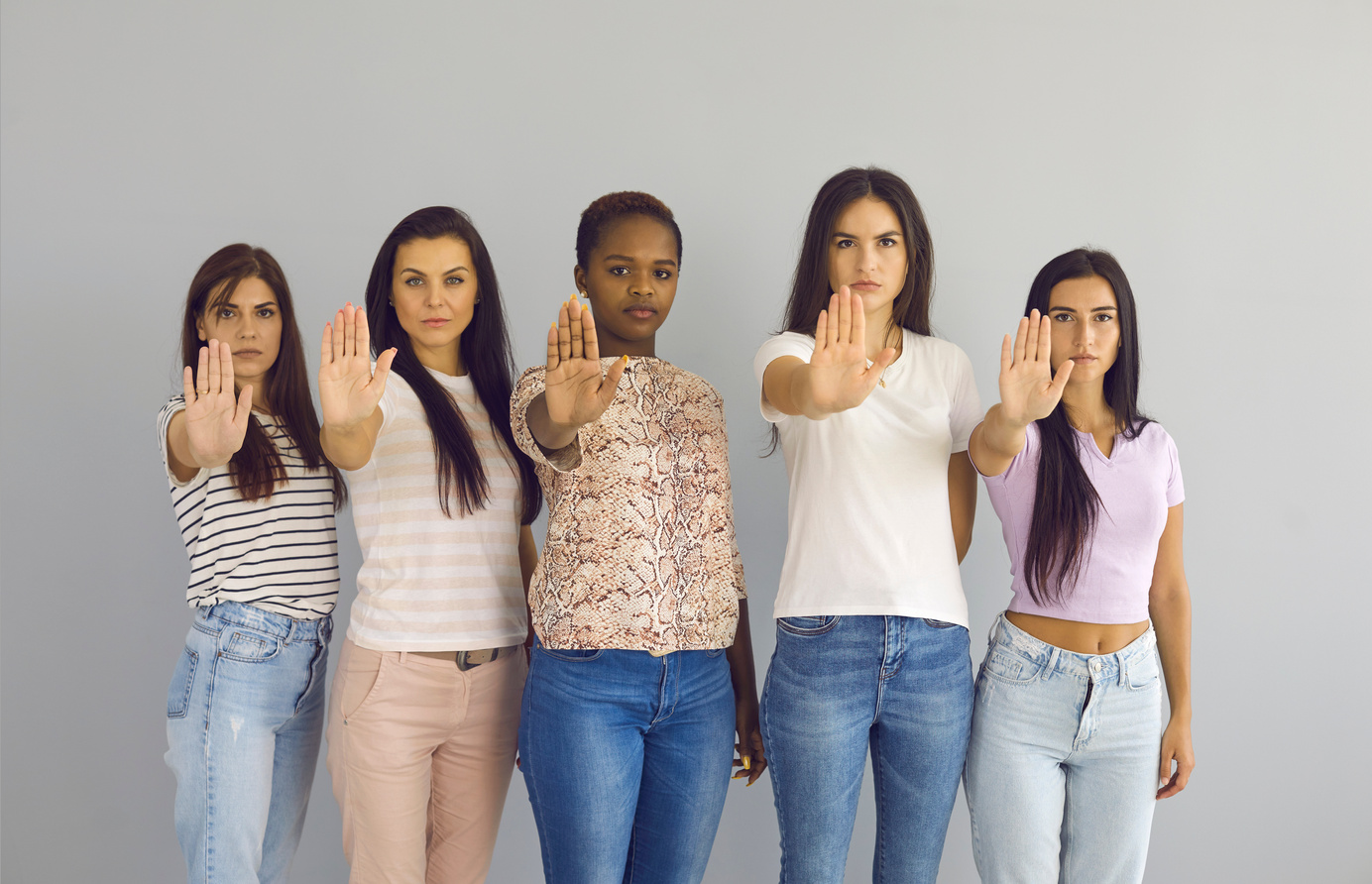 Group of Serious Women Doing Stop Hand Sign Gesture Saying No to Sexism and Violence